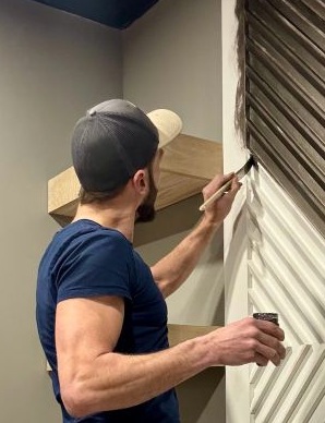 Mike painting a custom accent wall on site